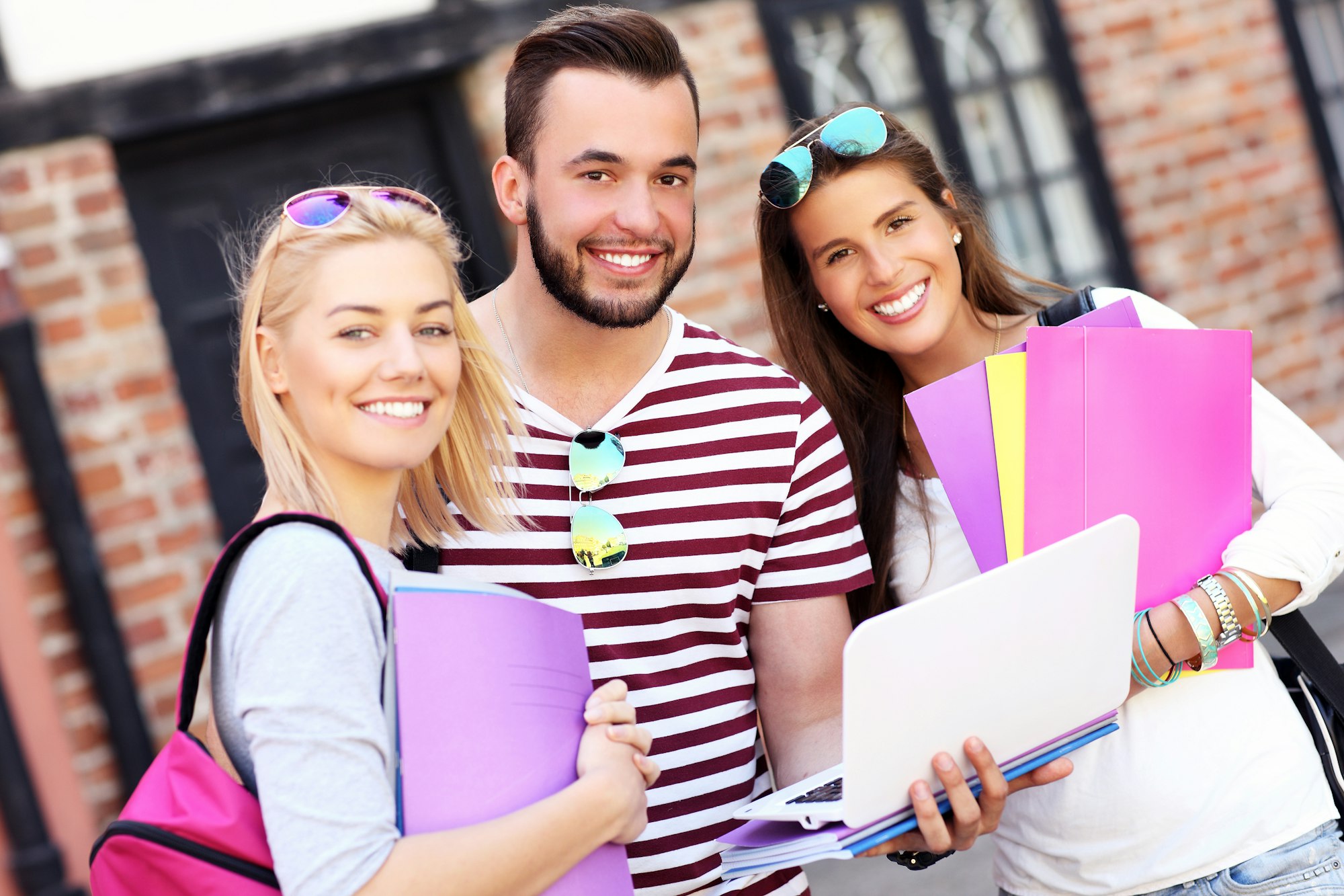 Group of happy students studying outdoors